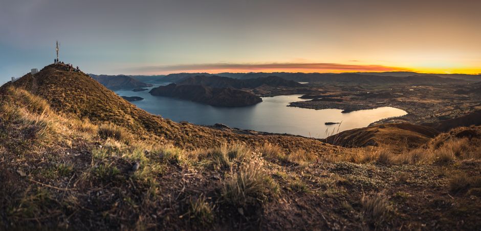 Beautiful panoramic view of Lake Wanaka from a hilltop at sunrise in New Zealand.