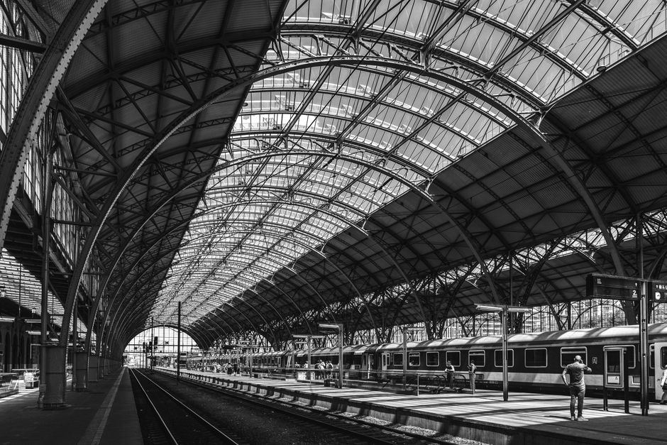 Black and white image of Prague's iconic train station showcasing architectural detail.