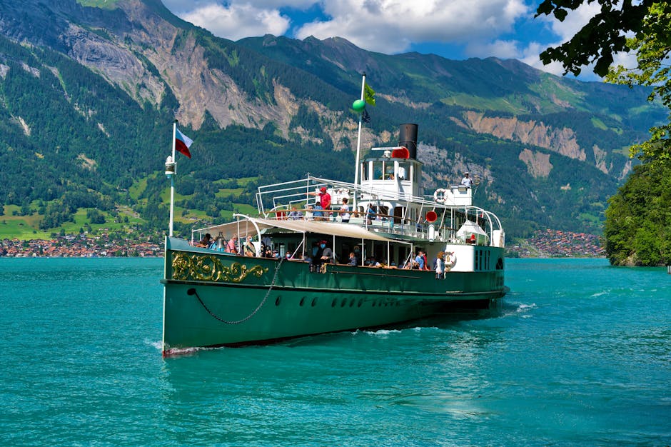 A picturesque sailing ship navigating the turquoise waters of Lake Brienz, set against the Swiss Alps in Iseltwald, Switzerland.