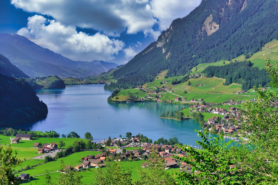 Picturesque towns by a lake with mountains in Switzerland during summer.