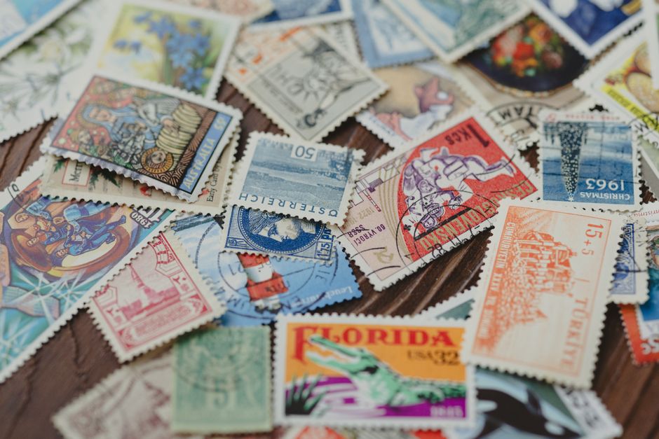 A vibrant collection of vintage postage stamps from different countries, showcasing diverse designs.