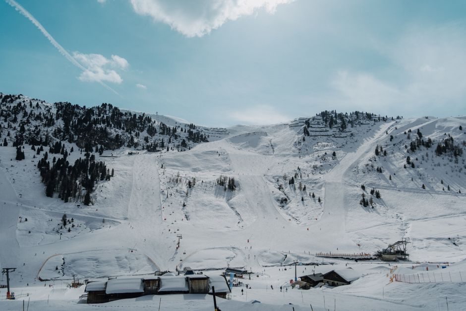 A panoramic view of snow-covered mountains at a ski resort in Tirol, Austria.