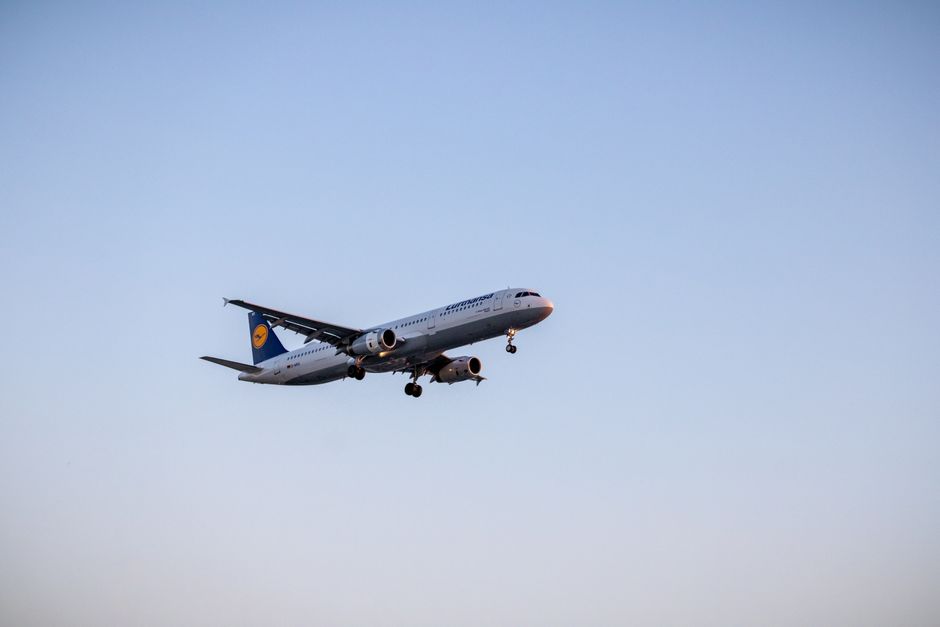 Passenger airplane in flight against blue sky, showcasing air travel and aviation technology.