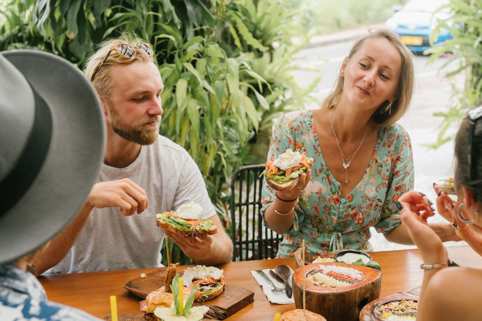 Group of friends enjoying a fresh, healthy meal outdoors during the summer.