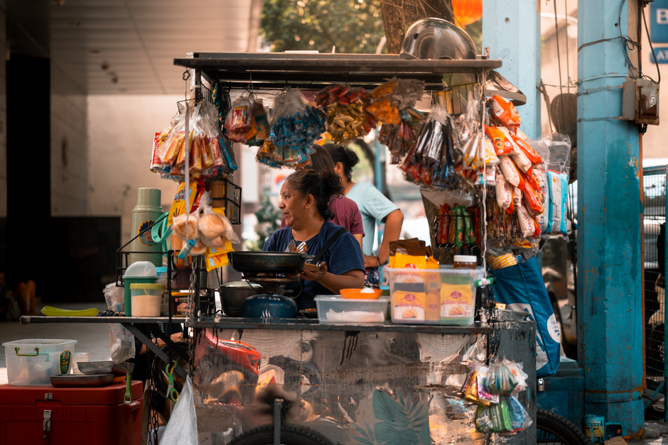 A street food vendor serving snacks in bustling Manila, Philippines street.