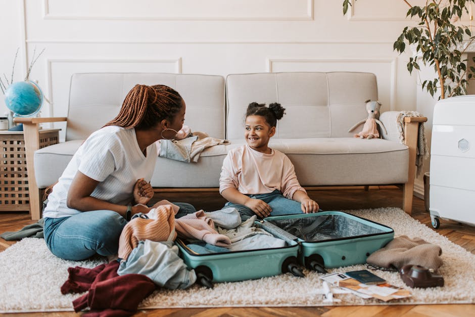 Mother and daughter packing a suitcase together at home, enjoying family time.