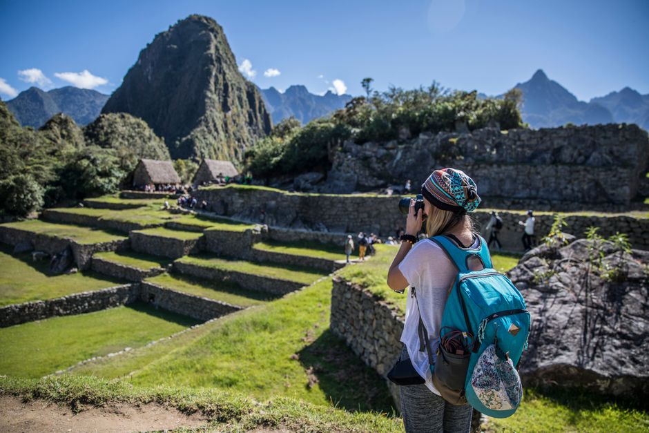 A traveler captures the beauty of Machu Picchu on a sunny day in Peru.