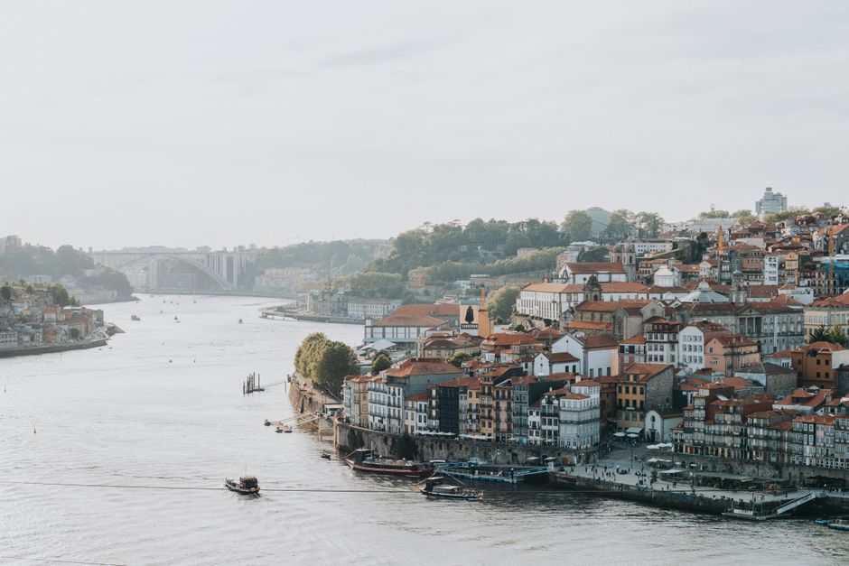 Peaceful Porto riverfront scene with historic architecture and soft lighting.