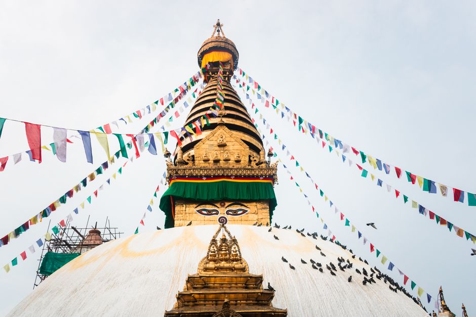 Vibrant prayer flags surround the iconic Swayambhunath Stupa in Kathmandu, Nepal.