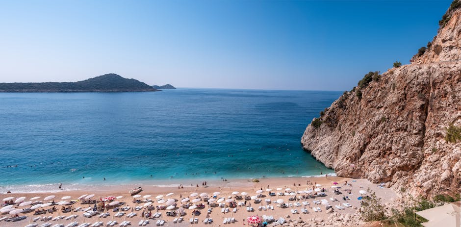Beautiful view of Kaputaş Beach, Antalya with sunbathers and turquoise waters.