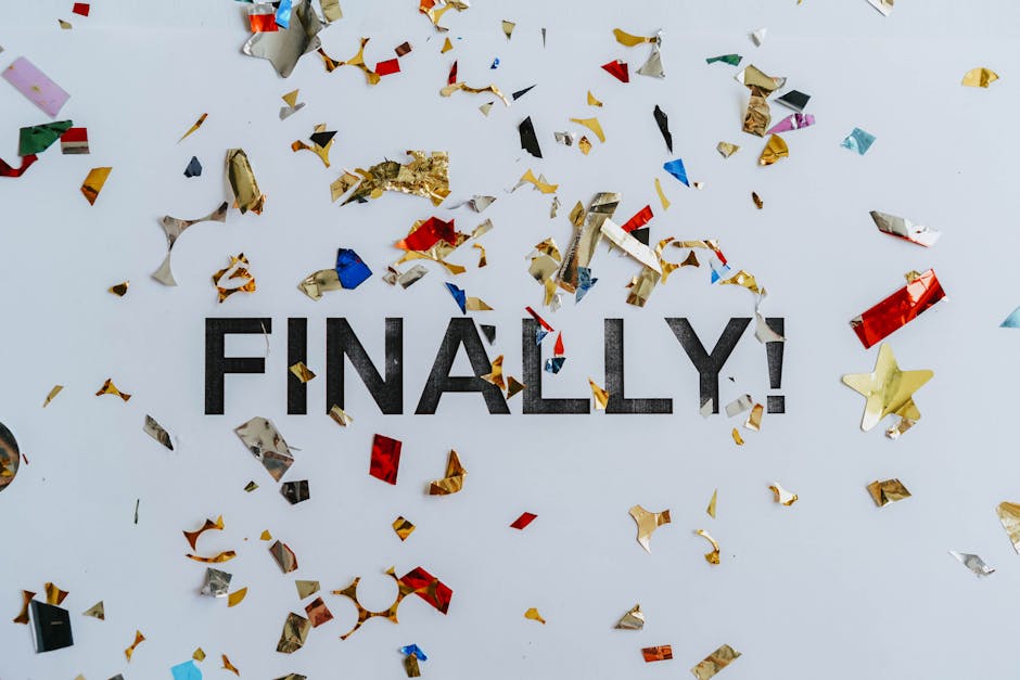 Colorful confetti scattered over the word 'Finally' symbolizing celebration or achievement.